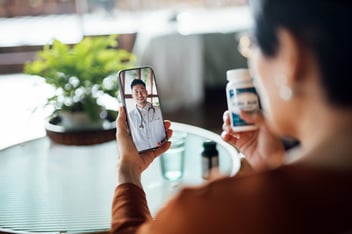 Patient attending a telehealth video visit with a clinician on a smartphone